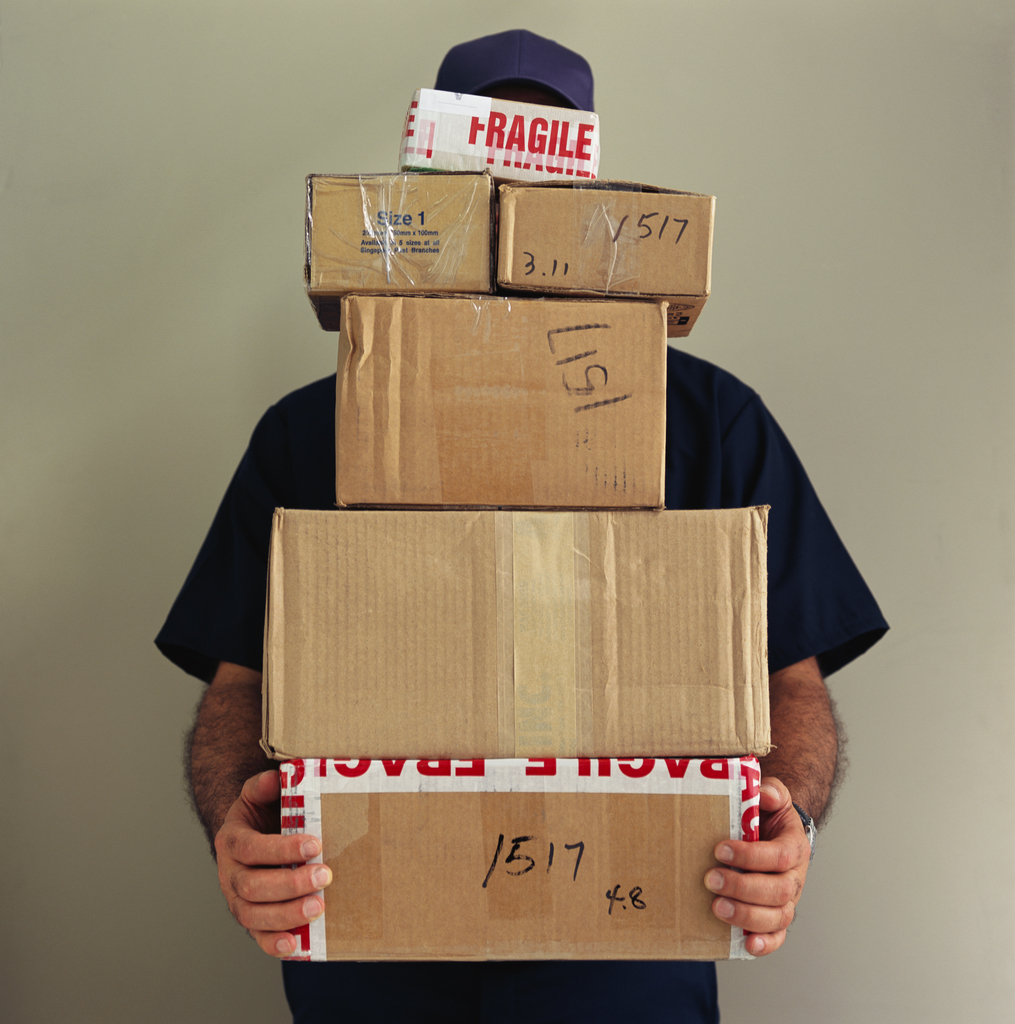 Delivery Man Balancing Boxes